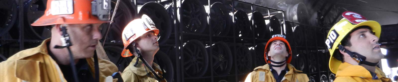 Firefighters assess the damage at a tire shop