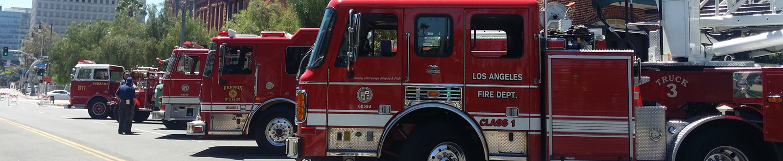 A long row of fire trucks on a street